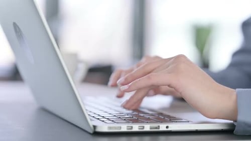 Close Up of Hands of Female Typing on Laptop Keyboard
