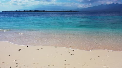 Peaceful serenity seascape with calm clear water of blue turquoise sea washing white sand of exotic