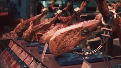 Jamons Are Standing on a Showcase in Traditional Spanish Market, for Sale