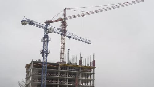 Cranes Constructing a High-Rise Building in the City