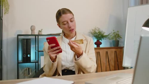 Business Woman Making Online Purchase Payment Shopping with Credit Bank Card Smartphone at Office