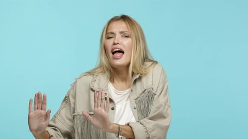 Slow Motion of Carefree Blond Woman Having Fun Dancing with Music and Singing Along Standing Over