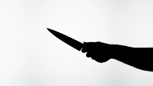 Man Holding Knife Closeup Shadow Silhouette of Hand with Weapon