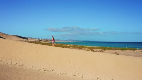 Aerial View of a Person Walking Among the Dunes in the Desert at Natural Park Near to Costa Calma