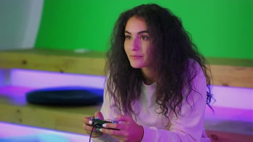 Woman with Curly Hair Plays Video Game