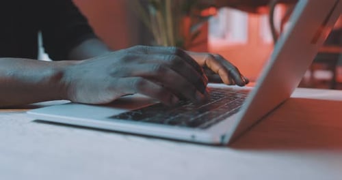 Man Working on Laptop Computer Indoors