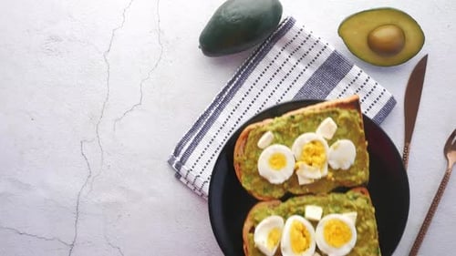 Avocado Toast With Eggs on Table Top View