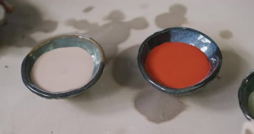 Close up view of female potter working on clay to create pot at pottery studio