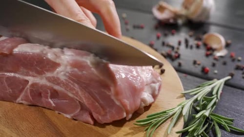 Fresh Pork Loin Being Cut into Steaks