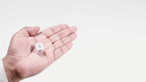 Hand Holds Numbered Dice Six