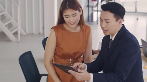 Excited manager showing plan project to a creative employee in the modern office.