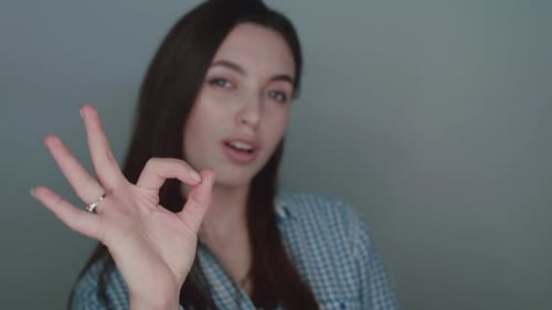 Woman Smiling and Making Ok Gesture