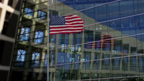 Waving American Flag on Flagpole in Modern Setting