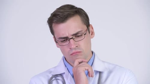 Young Serious Man Doctor Thinking While Looking Down