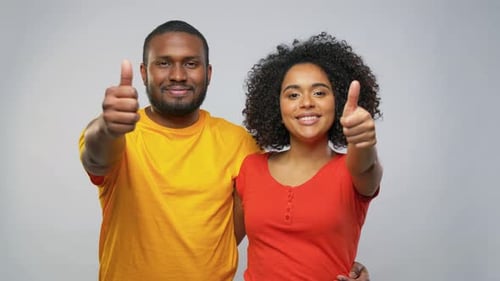 Smiling Couple Posing and Giving Thumbs Up