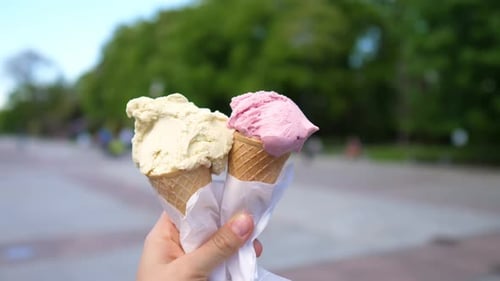 Person Holding Two Delicious Ice Cream Cones