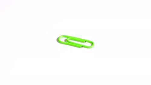 Green Paper Clip Rotates on White Background