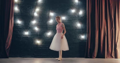 Graceful Ballerina Dancing in a Lighted Dance Studio