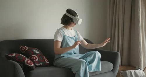 Young Adult Wearing a VR Headset on Couch