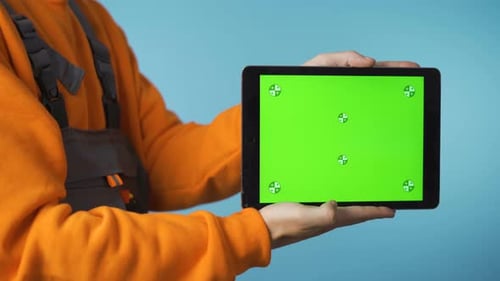 Repairman with Green Screen Tablet in His Hand