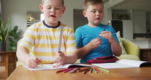 Boys Do Homework At Home On Table