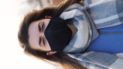 Woman Wearing Black Mask and Plaid Scarf