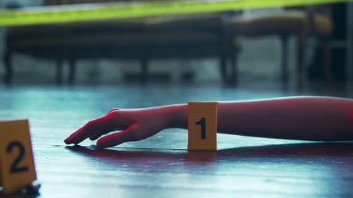 Evidence Markers at Crime Scene with Person's Hand