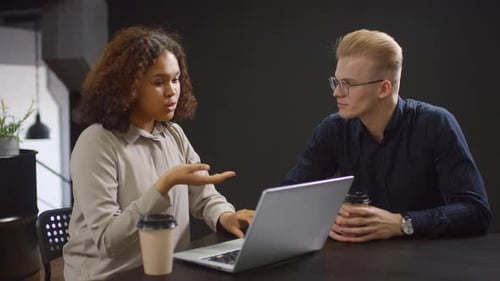 Woman Works on Laptop, Man Brings Coffee