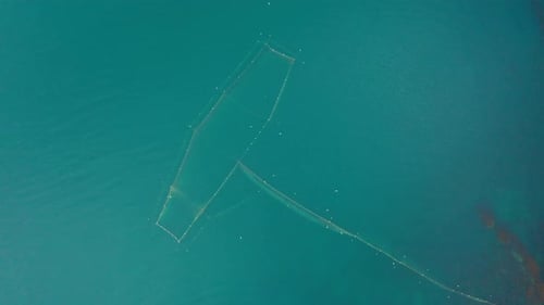 Drone flight above fishing nets in the sea water