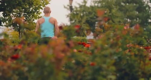 Young Man Runs in the Park