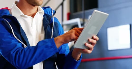 Young Adult Using Tablet Device Indoors