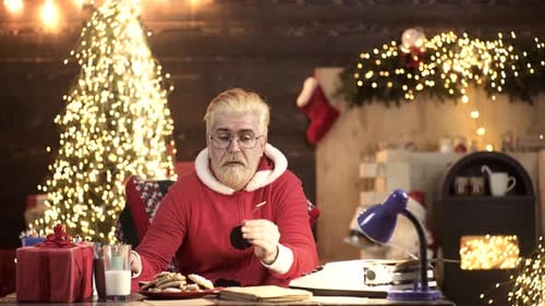 Person in Santa Suit Lights Sparkler at Christmas