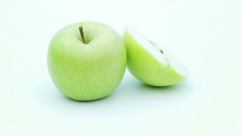 Green Apple and Slice on White Background