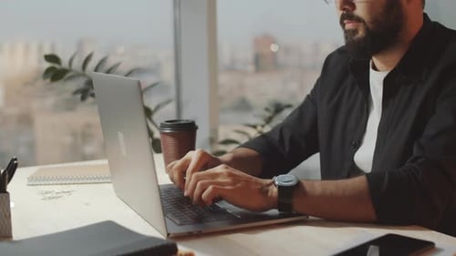 Close Up of Bearded Man Working Laptop at Office Desk