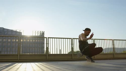 Man Breakdancing Outdoors on a Sunny Day