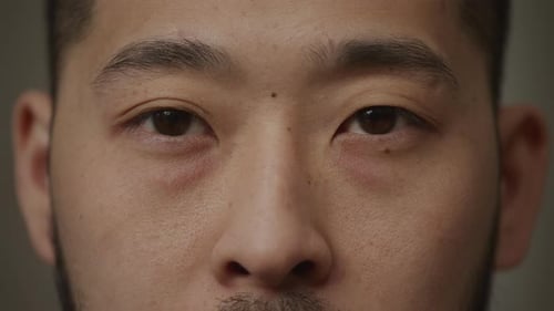 Extreme Close Up of an Asian Man's Eyes Opening and Looking at Camera
