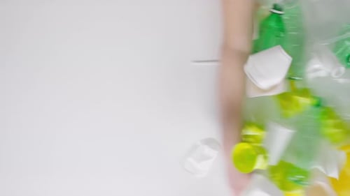 Plastic Waste Being Swept Away on White Background