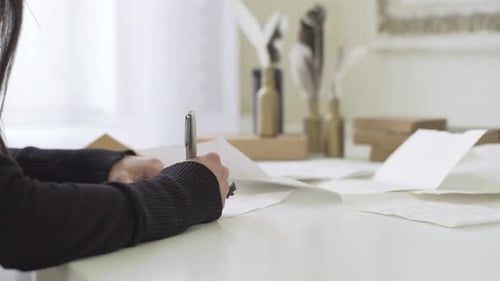 Girl with Beautiful Hands Writing a Letter at the Table