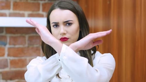 Woman Signals No with Arms in Front of Face