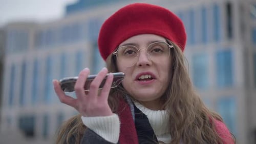 Young Woman Using Voice Assistant on Smartphone