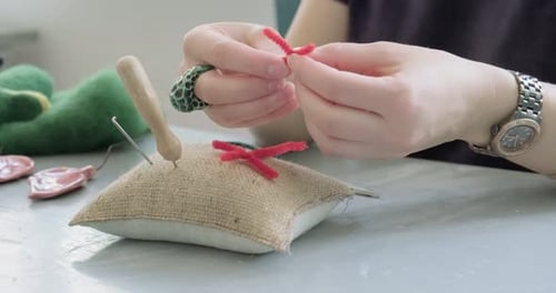 Woman Making Wool Art Doll Toy at Table Close Up. Female Sitting and Creating Ooak Doll at Home