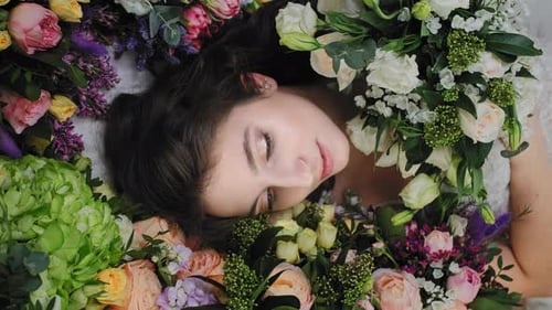 Beautiful Woman Lying in a Bed of Flowers