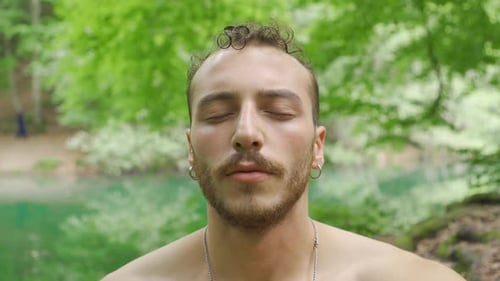 Man Meditating by a Lake, Close Up