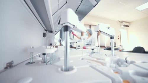 Woman Scientist or Researcher of a Modern Laboratory on the Background of an Immunochemical Blood