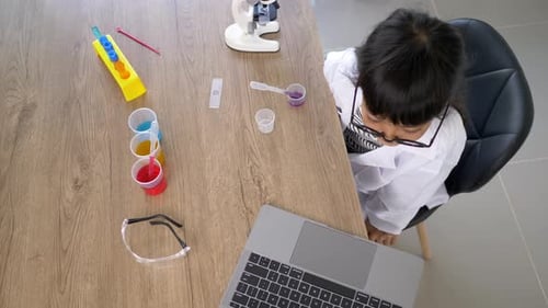 Young Girl Doing Science Experiment at Table