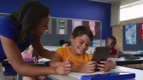 Smiling Boy Learning with Tablet in Classroom