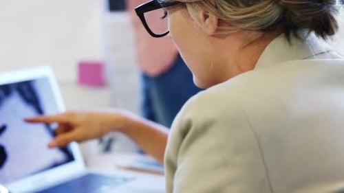 Women Working Together at a Desk in Office