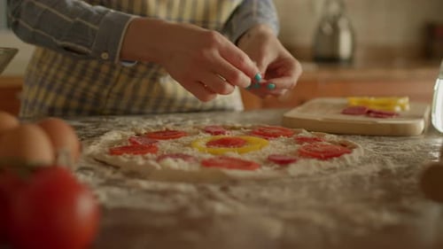 Close Up of Female Hands Placing Ingredients for Pizza