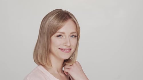Studio portrait of young, beautiful and natural blond woman.