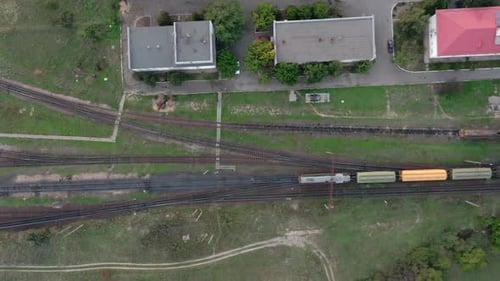 An Aerial Drone View of a Rail Freight Train Moving Through the Station